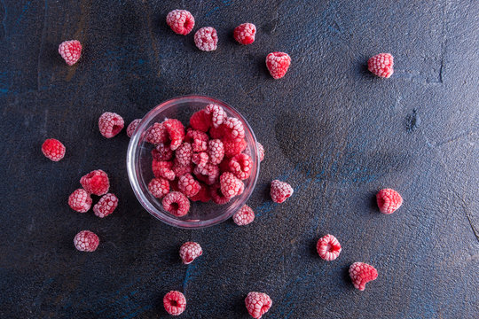 Frozen raspberries in glass bowl