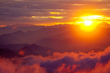 Fototapeta na wymiar Orange sunset above mountain in valley Himalayas mountains
