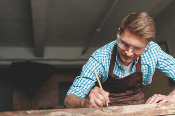 Working smiling master in carpentry