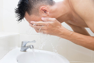 Man wash face in bathroom