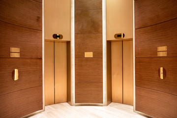 Closed elevator doors. Contemporary interior wooden curve