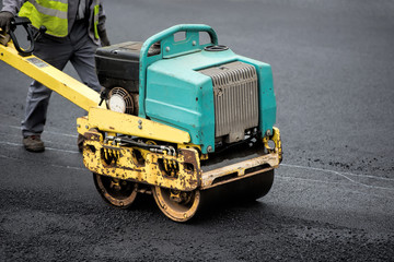 tamp new tarmac on the road