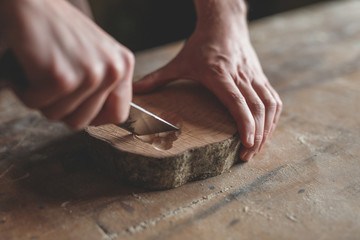 Men's hands with wood in carpentry