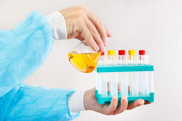 Hands of laboratory assistant doing chemical analysis in the laboratory