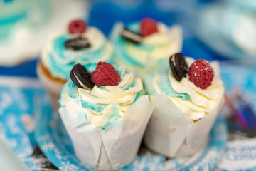 Blue cream cakes with berries