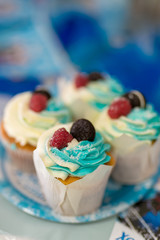 Blue cream cakes with berries