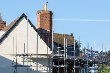 Scaffold platform erected for construction repair work on rural building