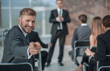 Fototapeta premium businessman sitting in the conference room, pointing at you