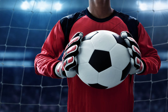 Soccer goalkeeper holding soccer ball