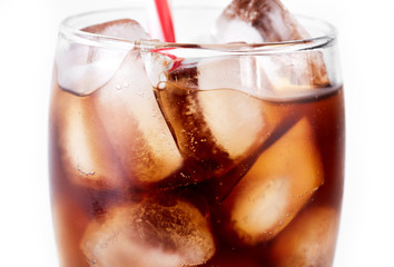 Cola in glass with straw and ice cubes isolated on white background. Soda with bubbles isolated on white. Refreshing non-alcoholic drink