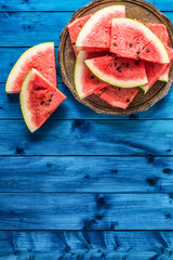 Top of view pieces of fresh watermelon on blue table