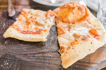 close up of pepperoni pizza on wooden desk, selective focus