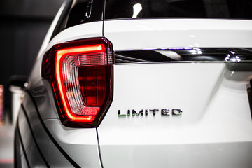 Rear stop light of large SUV car with Limited emblem