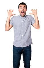 Handsome man making surprise gesture on isolated white background