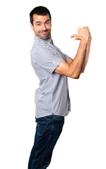 Handsome man proud of himself on isolated white background