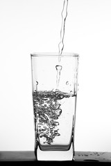 Water pouring into the clear glass