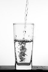 Water pouring into the clear glass