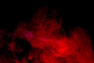 Red smoke isolated on black background.