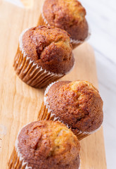 Top side view close up brown muffin or banana cake on white table and hands background for breakfast in morning day.