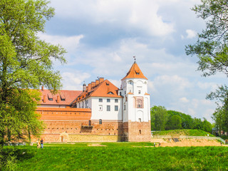 Obraz na płótnie Canvas Mir, Belarus. Castle Complex Mir On Sunny Day with blue sky Background. Old medieval Towers and walls of traditional fort from unesco world heritage list
