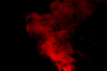 Red smoke isolated on black background.