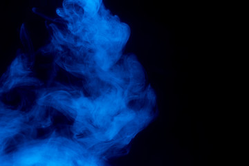 Obraz na płótnie Canvas Blue smoke isolated on black background.