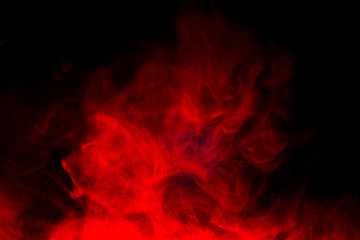 Red smoke isolated on black background.