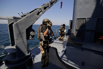 Romanian special forces marines are dropped in a rubber speed boat from the ‘Regele Ferdinand’...