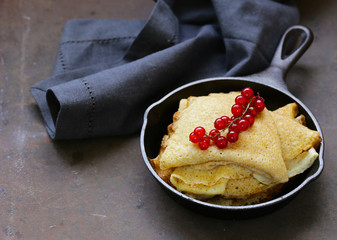 thin pancakes stack in a frying pan, rustic still life