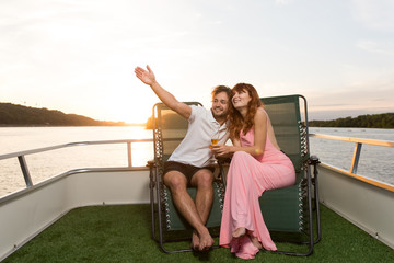 The couple admires the beautiful views of nature from yacht