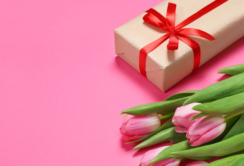 tulips with a gift on a pink background