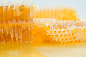 Piece of honeycomb with honey in closeup, healthy products by organic ingredients