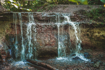 Dauda waterfall in dry summer .Small waterfall in Gauja national park. Latvia. Soft focus.Close up.