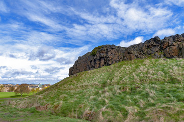 Fototapeta na wymiar A hillwalking route through grassy slopes up to Arthur’s Seat, the highest point in Edinburgh located at Holyrood Park, Scotland, UK