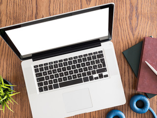 Books, headphones and laptop on a table. Top view