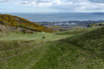 Fototapeta premium A hillwalking route through grassy slopes up to Arthur’s Seat, the highest point in Edinburgh located at Holyrood Park, Scotland, UK