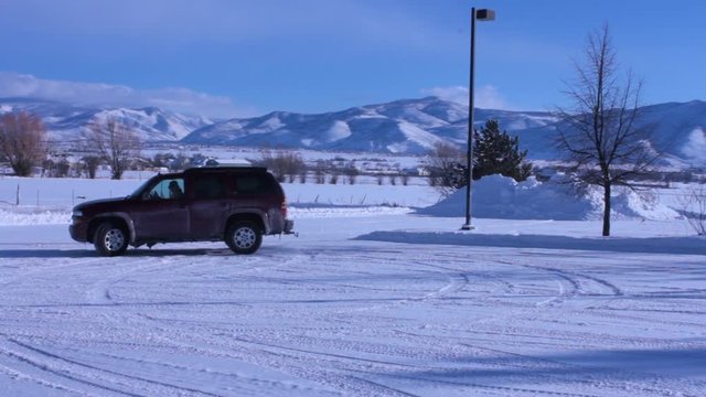 Brody's, donuts, spin outs, or whatever you call them this vehicle is having fun in a snowy parking lot slipping and sliding on the ice.