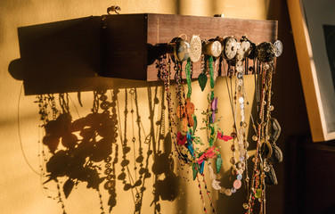 Necklaces  hanging on homemade wooden holder with knobs
