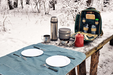 Preparing the meal in the winter hike at the table in the campsite.