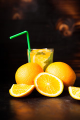 Fresh organic orangeade made of natural fruits on vintage wooden background