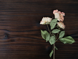Fototapeta na wymiar flowers on dark wooden background,flat lay