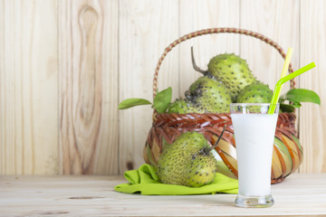 Soursop  basket and juice or Prickly Custard Apple or Annona muricata L on wooden table.