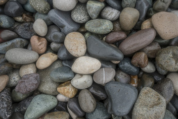 Fototapeta na wymiar wet pebble on beach abstract pattern texture background