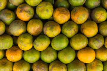 Tangerine, Thai orange ,Asian orange, Thai fruit, Thai traditional fruit.Fresh Oranges background,sweet green Thai orange for sale.