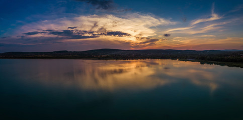 Fototapeta na wymiar Balatonfuzfo, Hungary - Beautiful panoramic sunset with reflection at Fuzfoi-obol taken above Lake Balaton