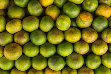 Tangerine, Thai orange ,Asian orange, Thai fruit, Thai traditional fruit.Fresh Oranges background,sweet green Thai orange for sale.