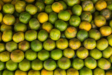 Tangerine, Thai orange ,Asian orange, Thai fruit, Thai traditional fruit.Fresh Oranges background,sweet green Thai orange for sale.