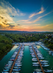 Fototapeta na wymiar Balatonfuzfo, Hungary - Beautiful sunset over yacht marina at Balatonfuzfo