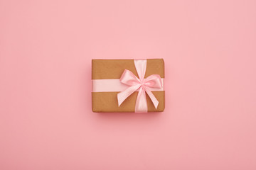 Present box with pink bow placed in the middle