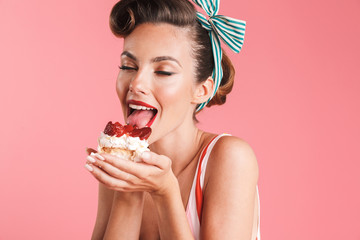 Beautiful pin up woman isolated holding cake.